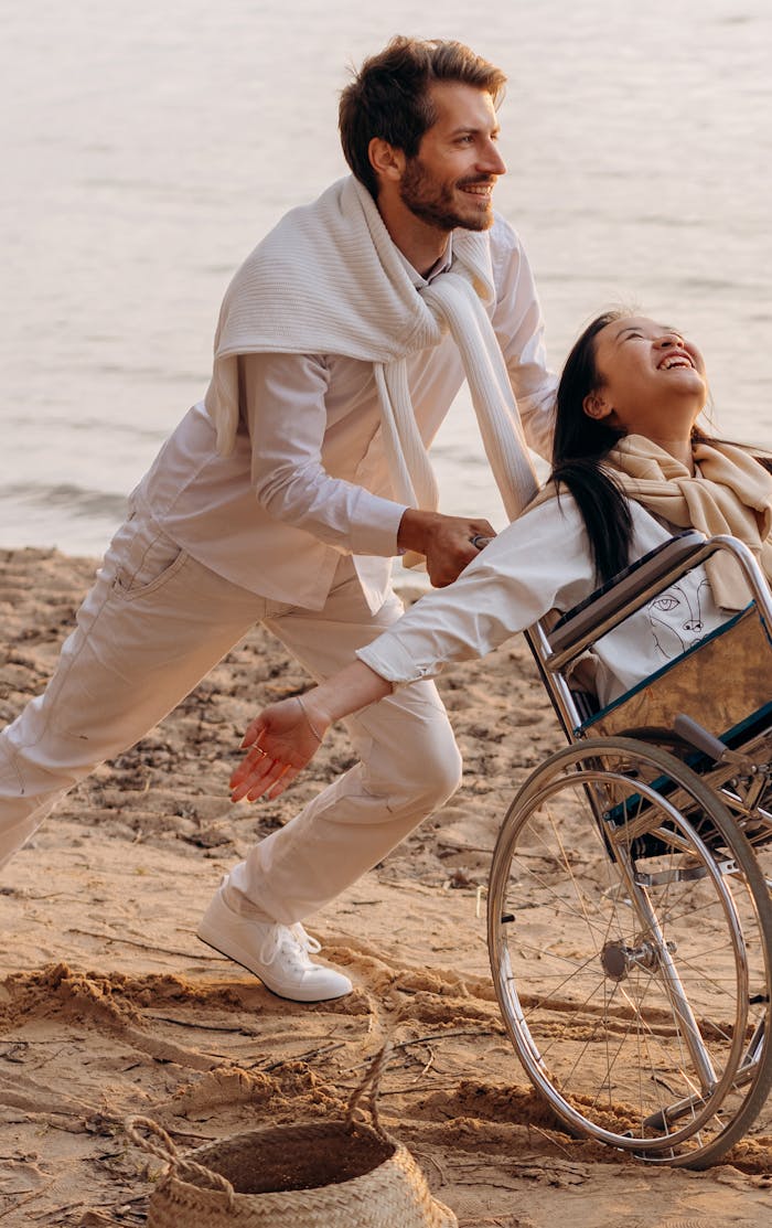 A couple shares a moment of happiness by the sea, embodying love and support.